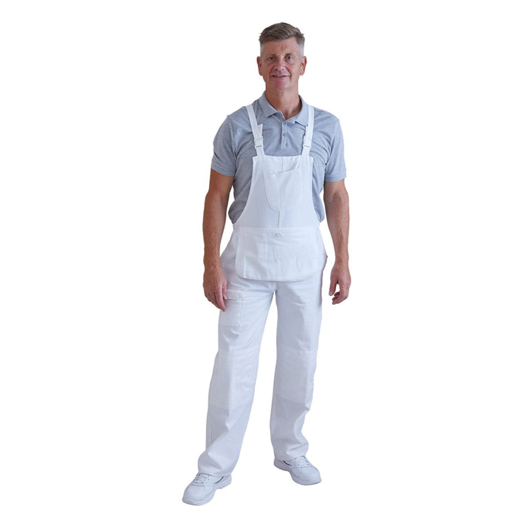 A man wearing white bib overalls over a light blue polo shirt and white shoes, standing against a plain white background.